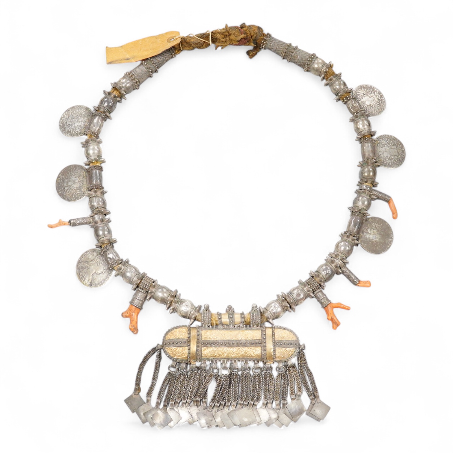 A Bedouin white metal and coral mounted necklace, from Oman, 58cm long